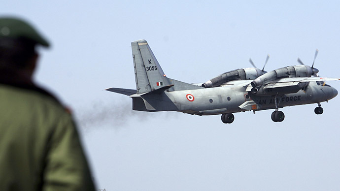 A soldier stands guard as an Indian Air Force AN-32 transport aircraft carrying security personnel takes-off from the technical airport in Jammu. (Reuters / Amit Gupta)