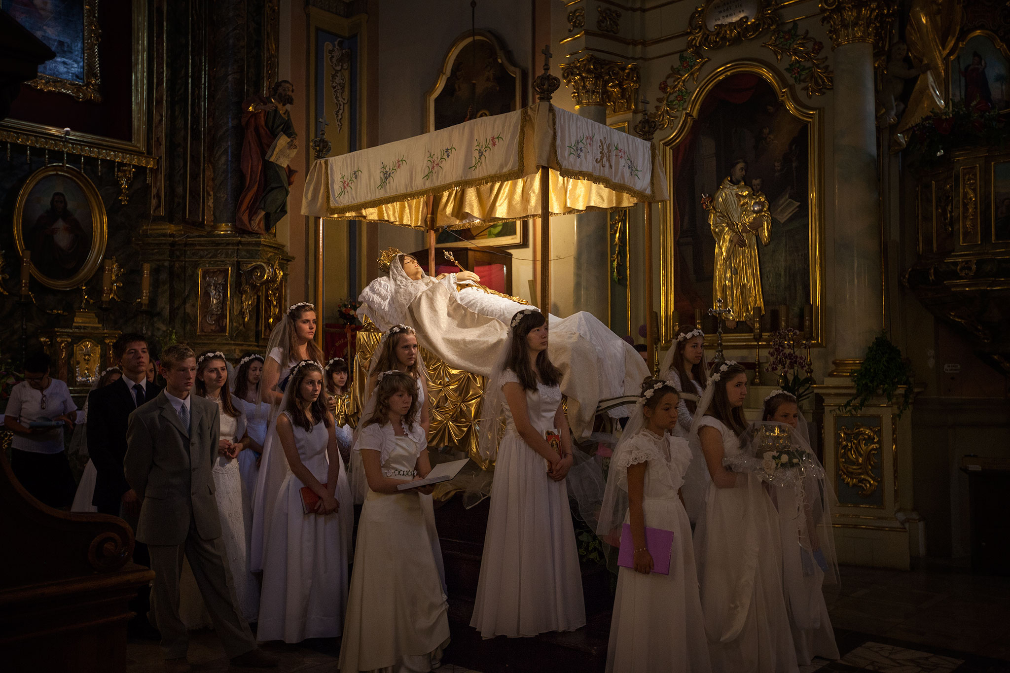 Mary is a magnet for young and old. On August 12, during a Mass celebrating her assumption into heaven, Roman Catholic youths guard a life-size figure in Kalwaria Pacławska, Poland. The Feast of the Assumption is a weeklong festival here.