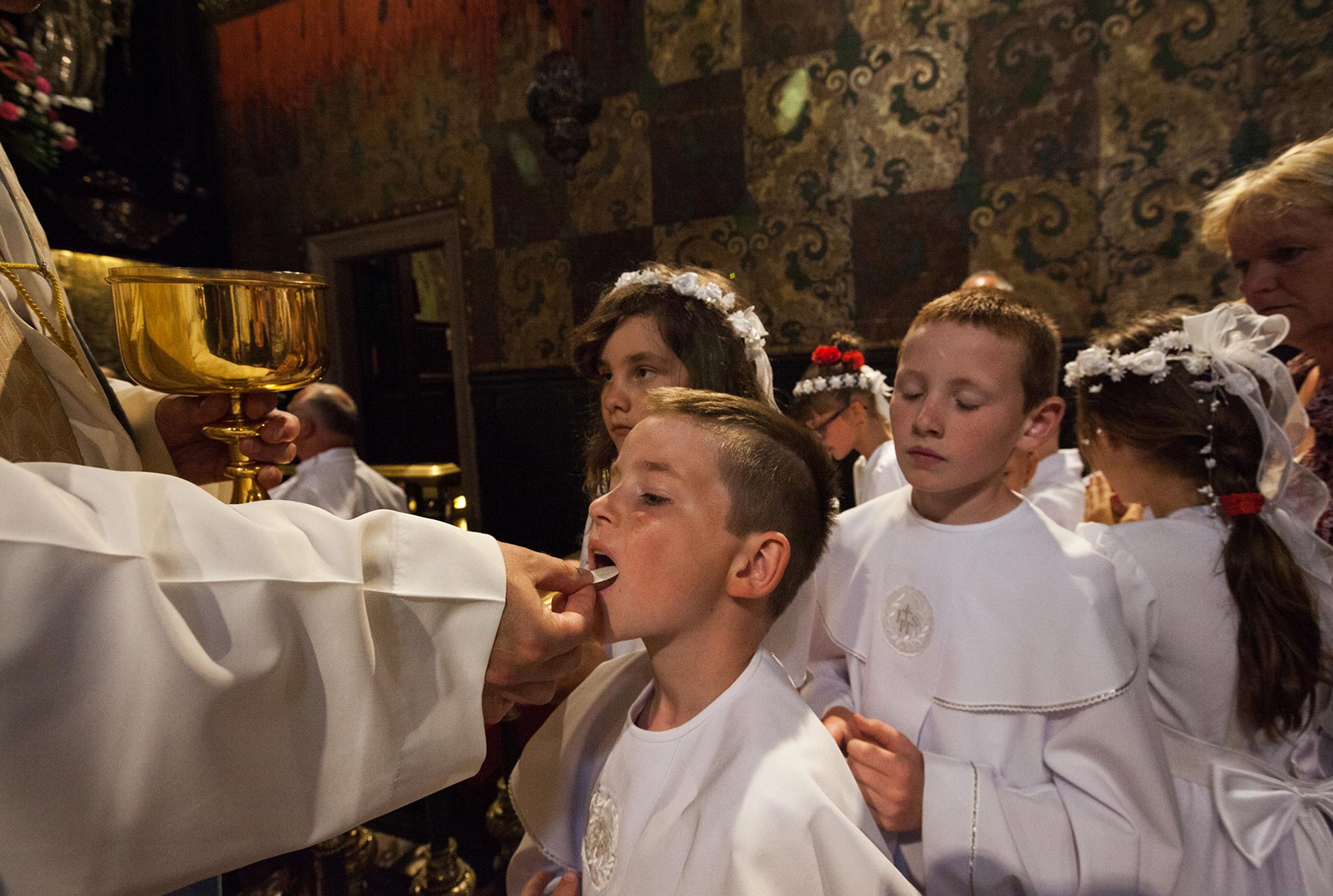 A boy receives Communion at the Jasna Góra Monastery, in Częstochowa, Poland. The Black Madonna—a revered painting of a dark-skinned Virgin Mary and Child Jesus, said to be the work of St. Luke—is housed in this sanctuary.