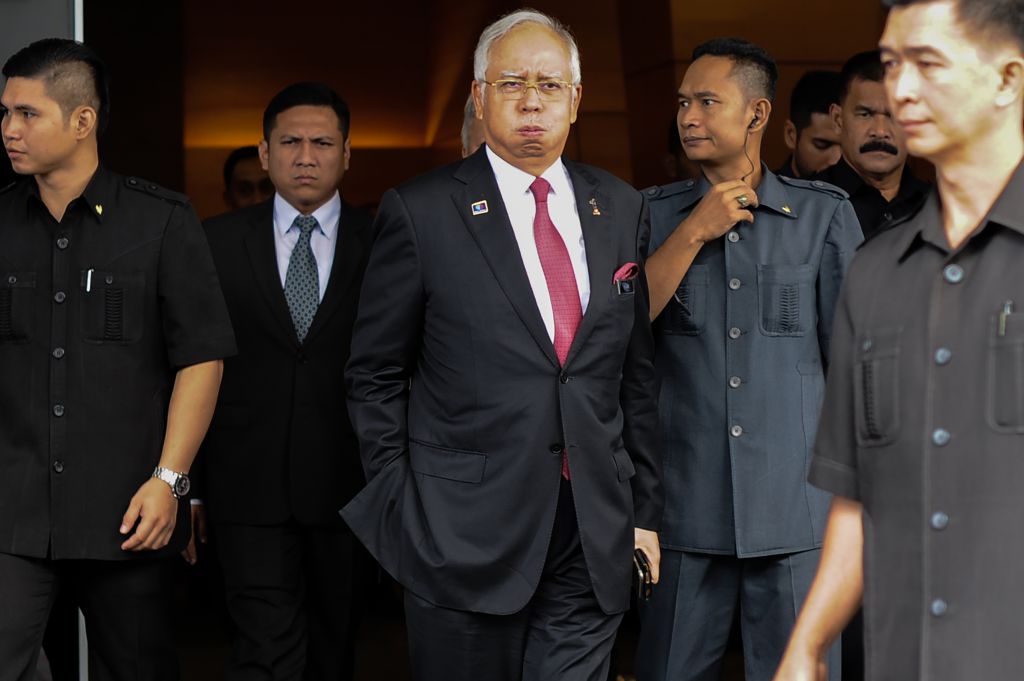 Malaysia's Prime Minister Najib Razak (C) reacts as he walks towards his car after attending a parliament session in Kuala Lumpur on January 26, 2016. The Saudi royal family was the source of a 681 million USD "donation" that has engulfed Malaysian Prime Minister Najib Razak in scandal, his attorney general said on January 26, in a statement clearing the premier of graft allegations. AFP PHOTO / MOHD RASFAN / AFP / MOHD RASFAN (Photo credit should read MOHD RASFAN/AFP/Getty Images)