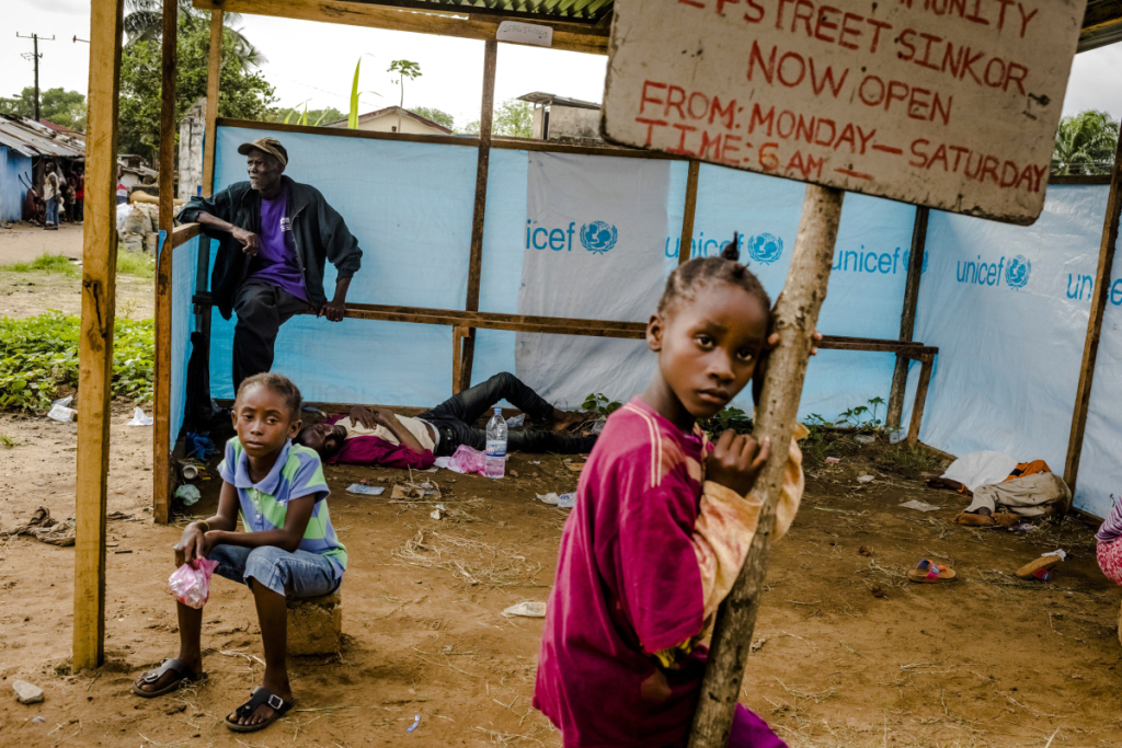 People wait to be admitted into an Ebola treatment facility in Monrovia, Liberia.