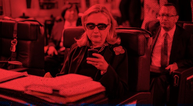 Secretary of State Hillary Clinton checks her phone on board a plane from Malta to Tripoli, Libya. (Kevin Lamarque / Reuters / Zak Bickel / The Atlantic)